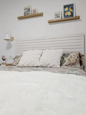 a bed with white sheets and pillows in a bedroom at Apartamento Victoria in San Fernando