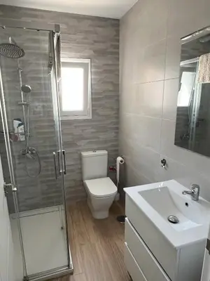 a bathroom with a shower and a toilet and a sink at Casa Álamo en Chipiona in Chipiona