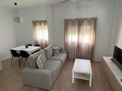 a living room with a couch and a table at Casa Álamo en Chipiona in Chipiona