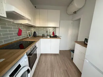 a kitchen with white cabinets and a stove top oven at Casa Álamo en Chipiona in Chipiona