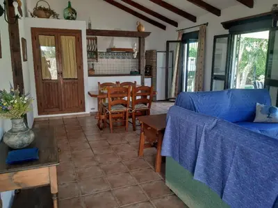 a living room with a blue couch and a table at Casa Juan José in Conil de la Frontera