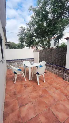 a patio with a table and chairs on a tile floor at EL Lucernario in Jerez de la Frontera
