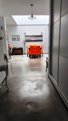 an empty room with a table and orange chairs at EL Lucernario in Jerez de la Frontera
