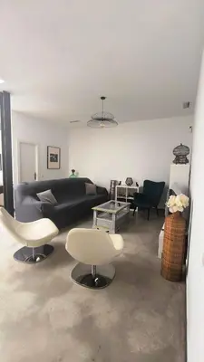 a living room with a black couch and chairs at EL Lucernario in Jerez de la Frontera