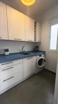 a kitchen with a sink and a washing machine at EL Lucernario in Jerez de la Frontera