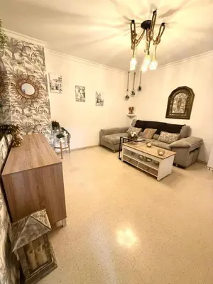 a living room with a couch and a table at Alojamiento Montero in Sanlúcar de Barrameda