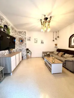 a living room with a couch and a table at Alojamiento Montero in Sanlúcar de Barrameda