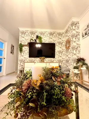 a living room with a table with flowers on it at Alojamiento Montero in Sanlúcar de Barrameda