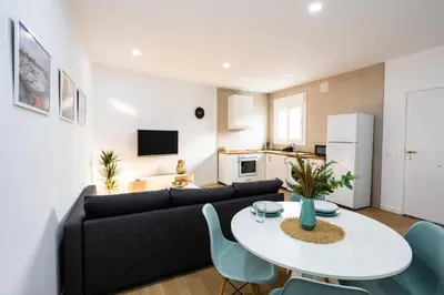 a living room with a couch and a table and chairs at La casita nueva in Cádiz