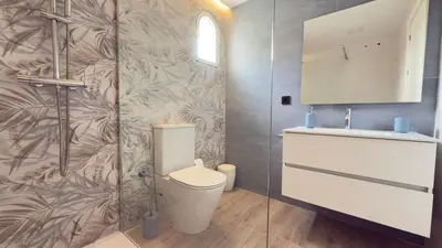 a bathroom with a toilet and a sink at Punto Mágico, apartamento junto al mar in Poblado de Sancti Petri