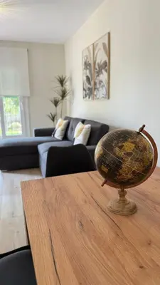 a globe on top of a wooden table in a living room at Punto Mágico, apartamento junto al mar in Poblado de Sancti Petri