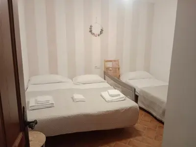 two twin beds in a room with a mirror at Villa Sofía in Chiclana de la Frontera