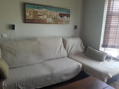 a white couch in a living room with a painting on the wall at Villa Sofía in Chiclana de la Frontera