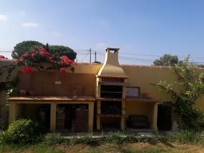 a small house with a chimney on the side of it at Villa Sofía in Chiclana de la Frontera