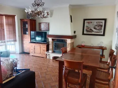 a living room with a wooden table and a fireplace at Villa Sofía in Chiclana de la Frontera