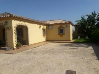 a house with a driveway in front of it at Villa Sofía in Chiclana de la Frontera