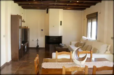 a living room with a couch and a table at Villa Dana in Chiclana de la Frontera