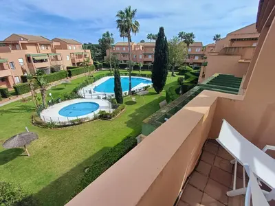 a view from the balcony of a apartment with a swimming pool at Ático 