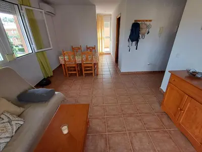 a living room with a couch and a table and chairs at Ático 