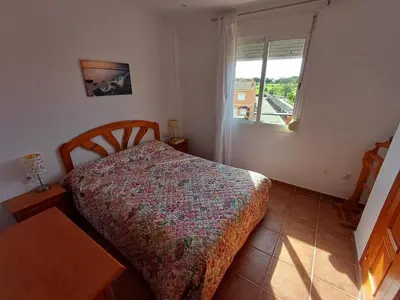 a bedroom with a bed and a window at Ático 