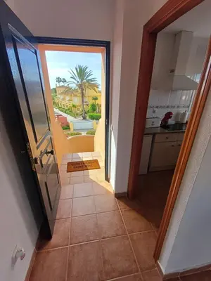 a hallway with a door to a kitchen with a view at Ático 