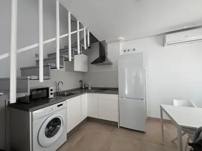 a kitchen with a washing machine and a sink at Alojamientos VICTORIA MAR-CHIPIONA- in Chipiona
