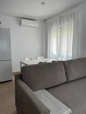 a living room with a couch in front of a window at Alojamientos VICTORIA MAR-CHIPIONA- in Chipiona