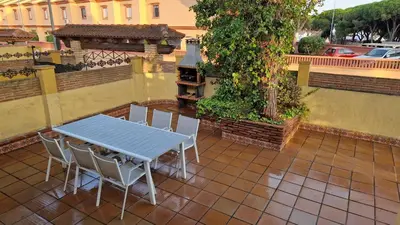 a blue table and chairs on a patio at La Barrosa - Chalet La Morenita in Chiclana de la Frontera