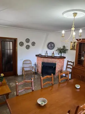 a living room with a table and a fireplace at La Barrosa - Chalet La Morenita in Chiclana de la Frontera