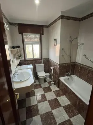 a bathroom with a toilet and a tub and a sink at La Barrosa - Chalet La Morenita in Chiclana de la Frontera