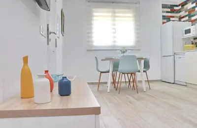 a kitchen with a table with vases on a counter at El Rincon de Lidia in Conil de la Frontera