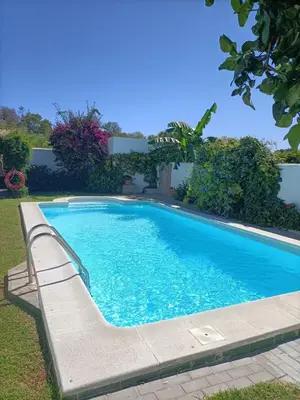 a swimming pool with a bench in a yard at Viangel 1 in Conil de la Frontera