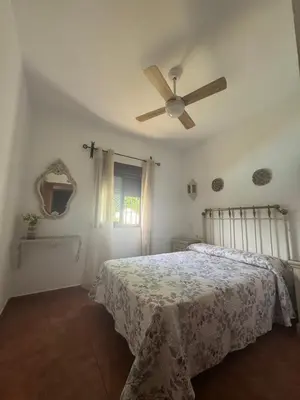 a bedroom with a bed with a ceiling fan at Viangel 1 in Conil de la Frontera