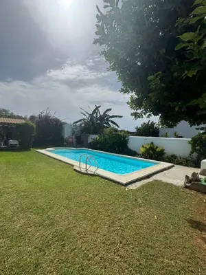 a swimming pool in the yard of a house at Viangel 1 in Conil de la Frontera