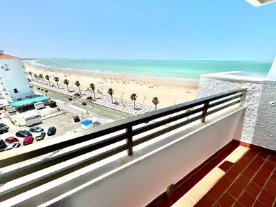a balcony with a view of a beach and the ocean at GATU Malvasía- Valdelagrana in El Puerto de Santa María