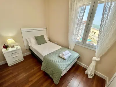 a small bedroom with a bed and a window at GATU Malvasía- Valdelagrana in El Puerto de Santa María