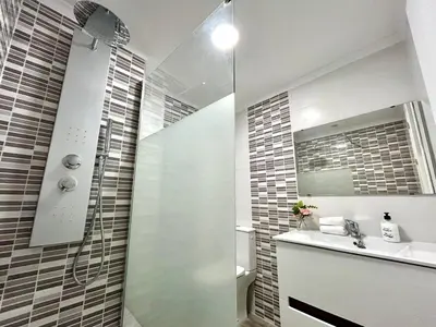 a bathroom with a shower and a sink and a mirror at GATU Malvasía- Valdelagrana in El Puerto de Santa María