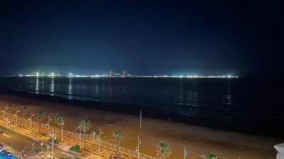 a bridge over the water at night with lights at GATU Malvasía- Valdelagrana in El Puerto de Santa María