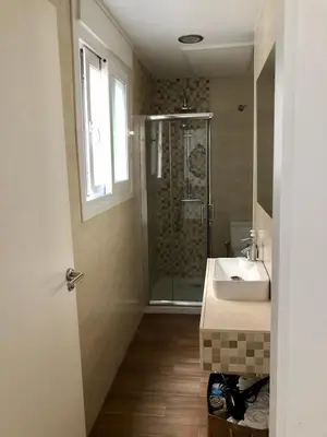 a bathroom with a shower and a sink at Luz de La Caleta in Cádiz