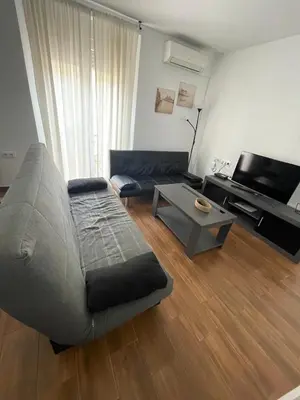 a living room with a couch and a table at Luz de La Caleta in Cádiz