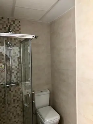 a bathroom with a toilet and a glass shower at Luz de La Caleta in Cádiz