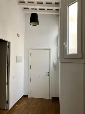an empty room with a white door and a window at Luz de La Caleta in Cádiz