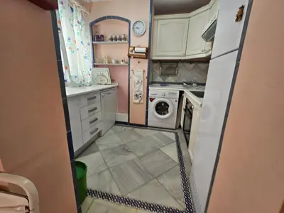 a small kitchen with a washer and dryer at Luxury apartment puerto sherry in El Puerto de Santa María