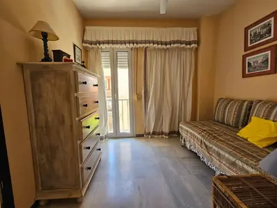 a living room with a couch and a dresser at Luxury apartment puerto sherry in El Puerto de Santa María