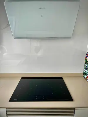 a kitchen with a microwave and a stove top oven at Ático Juan Grande 17 by Sanlúcar Housing in Sanlúcar de Barrameda
