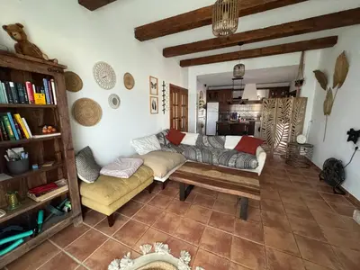 a living room with a couch and a table at Casa Tropical in Chiclana de la Frontera