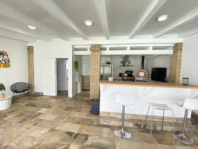a kitchen with a counter and stools in a room at Chalet Albariza in Sanlúcar de Barrameda
