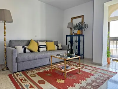 a living room with a couch and a table at Apartamento Sol Jerez - Ole Solutions in Jerez de la Frontera