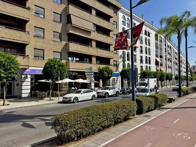 a street with cars parked in front of a building at Apartamento Sol Jerez - Ole Solutions in Jerez de la Frontera