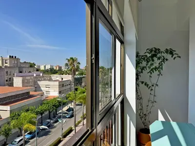 a window with a view of a city street at Apartamento Sol Jerez - Ole Solutions in Jerez de la Frontera